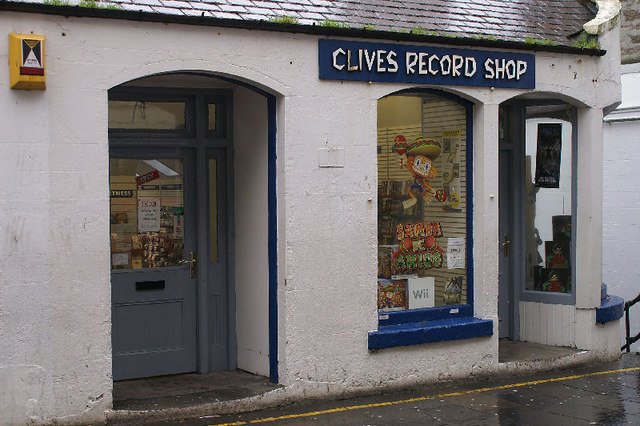 A record shop interior lined with crates of vinyl
